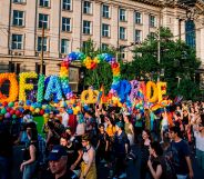 Revellers take part in a Pride parade in Sofia, Bulgaria in 2019 - a large sign written in balloons reads "Sofia Pride"