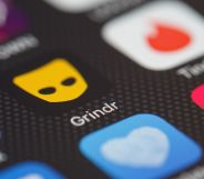 Stock image of the Grindr app logo on a phone