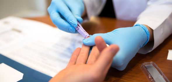 Person getting a finger-prick HIV test