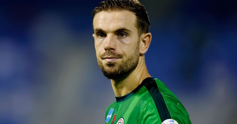 Jordan Henderson during a football match, wearing a green football shirt.