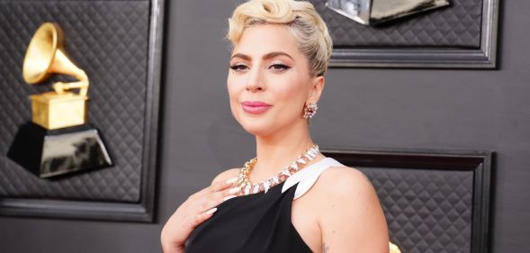 Lady Gaga in a black dress at the 2022 Grammy Awards.
