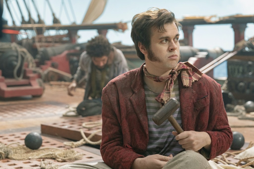 Lucius (Nathan Foad) siting on the deck of a ship. He was pushed overboard in the season 1 finale. (HBO)
