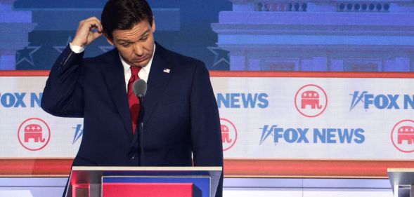 Ron DeSantis scratches his head on stage at the Republic National debate.