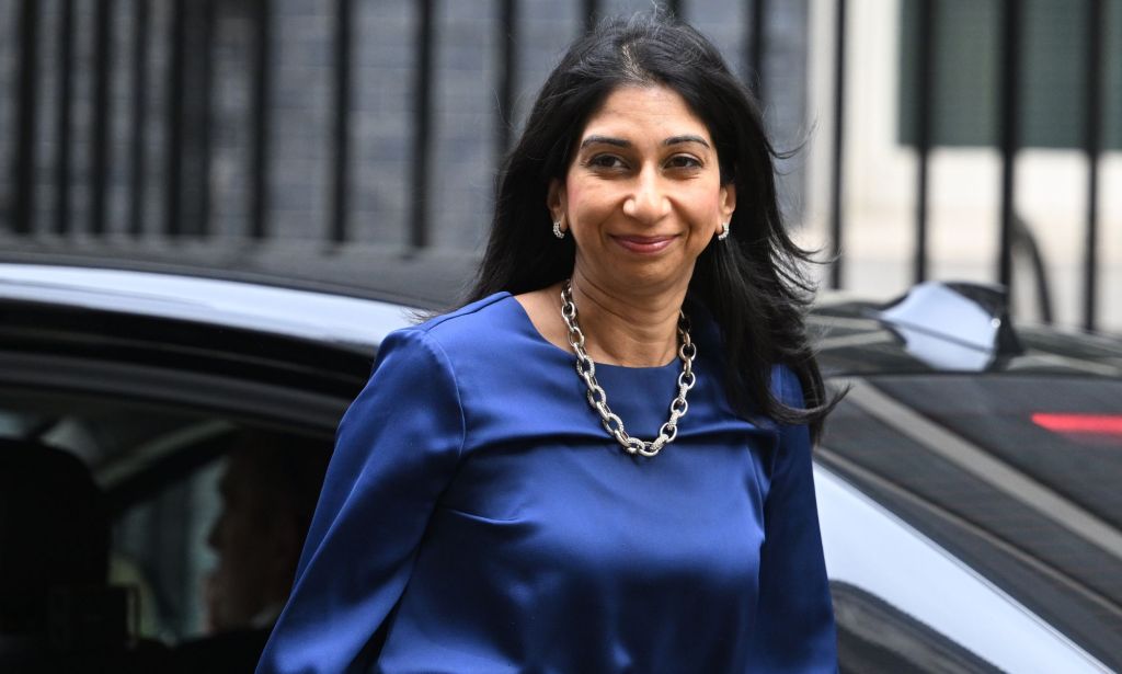 Home secretary, Suella Braverman wallking past a car.