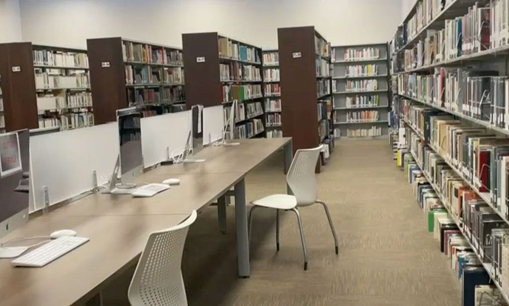 A picture of computers and shelves of books at an Alabama library to illustrate that several libraries across the state are facing backlash over LGBTQ+ inclusive books
