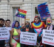 People hold up signs reading 'Ban LGBT+ conversion therapy NOW!' and 'conversion therapy is LGBT+ abuse' as they call on the Tory government to take action