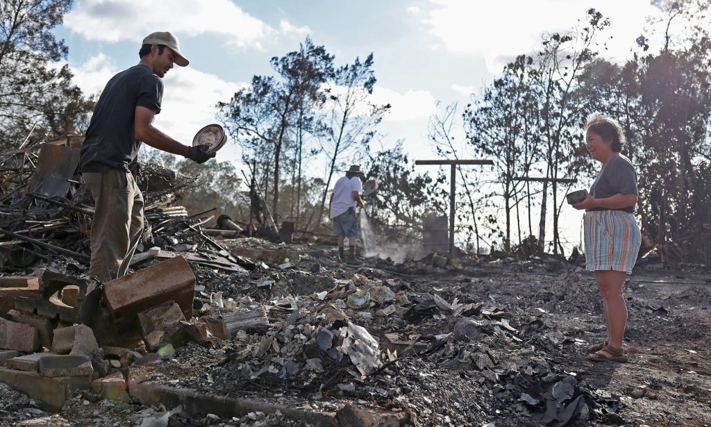 Various people shift through the rubble and ashes left behind by wildfires that devastated Maui, Hawaii