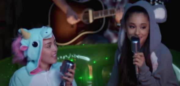 Miley Cyrus and Ariana Grande sing together.