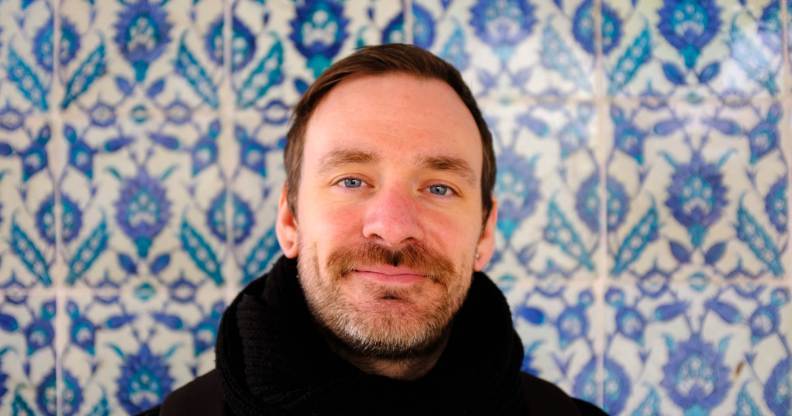 Stewart O'Callaghan, who has blood cancer, pictured against a patterned blue background.