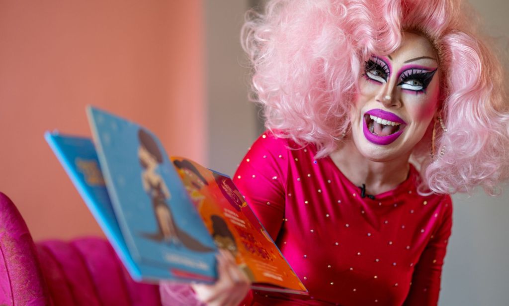 Texas drag queen Brigitte Bandit, who brought a legal case against the state's drag ban legislation, wears a pink wig and pink outfit as she reads from a book