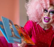 Texas drag queen Brigitte Bandit, who brought a legal case against the state's drag ban legislation, wears a pink wig and pink outfit as she reads from a book