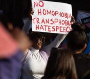A person holds up a sign reading 'No homophobia, transphobia, hate speech' during a protest against Uganda's anti-LGBTQ+ bill