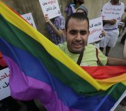 A protestor waves a Pride flag during an anti-homophobia rally in Beirut on 30 April 2013