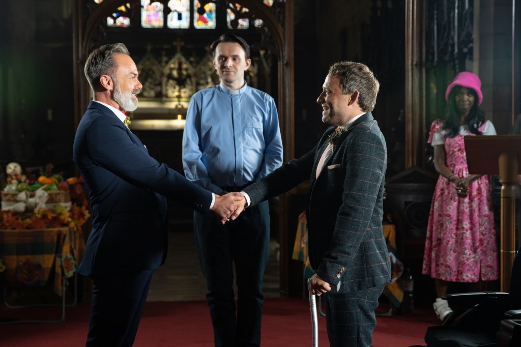 Peter Ash (right) as Paul and and Daniel Brocklebank as Billy (left) in church at their wedding on Coronation Street