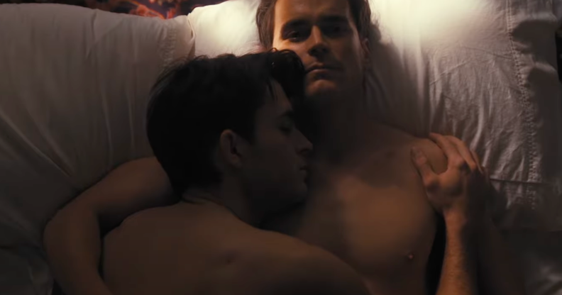 Jonathan Bailey (left) and Matt Bomer (right) lie in bed together in the trailer for Fellow Travelers