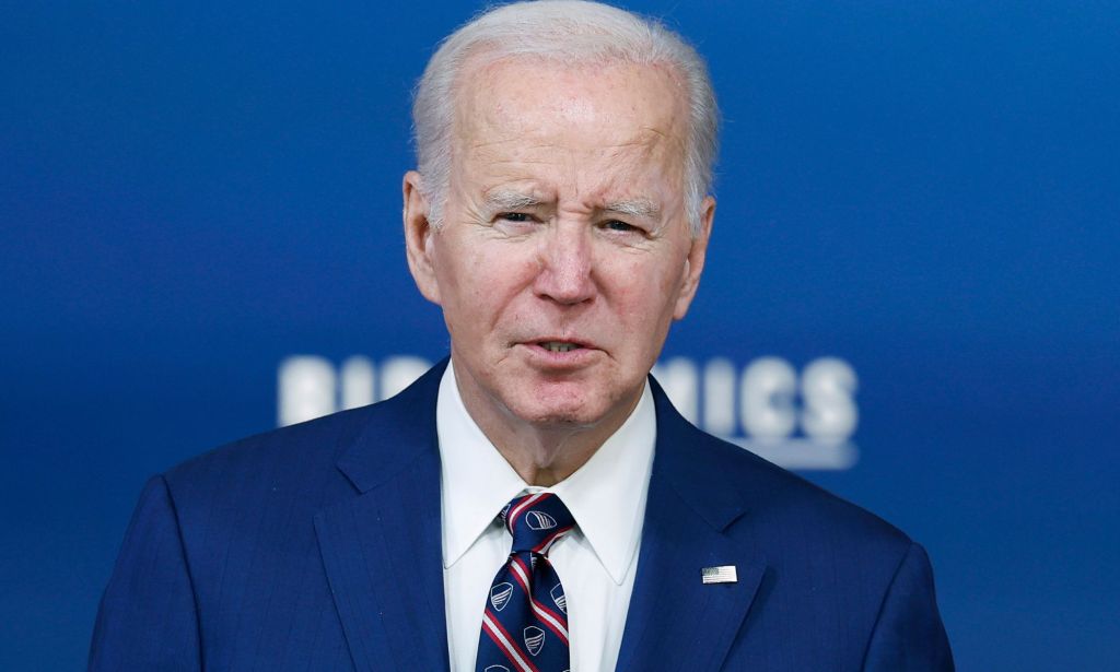 A shoulder-height picture of Joe Biden on stage of a Bidenomics conference.