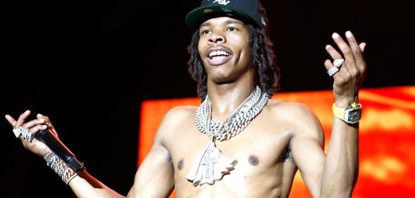 Lil Baby performs topless at 2022 Something In The Water Music Festival.