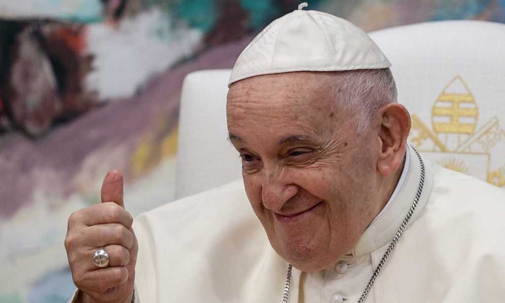 Pope Francis smiles while giving a thumbs up