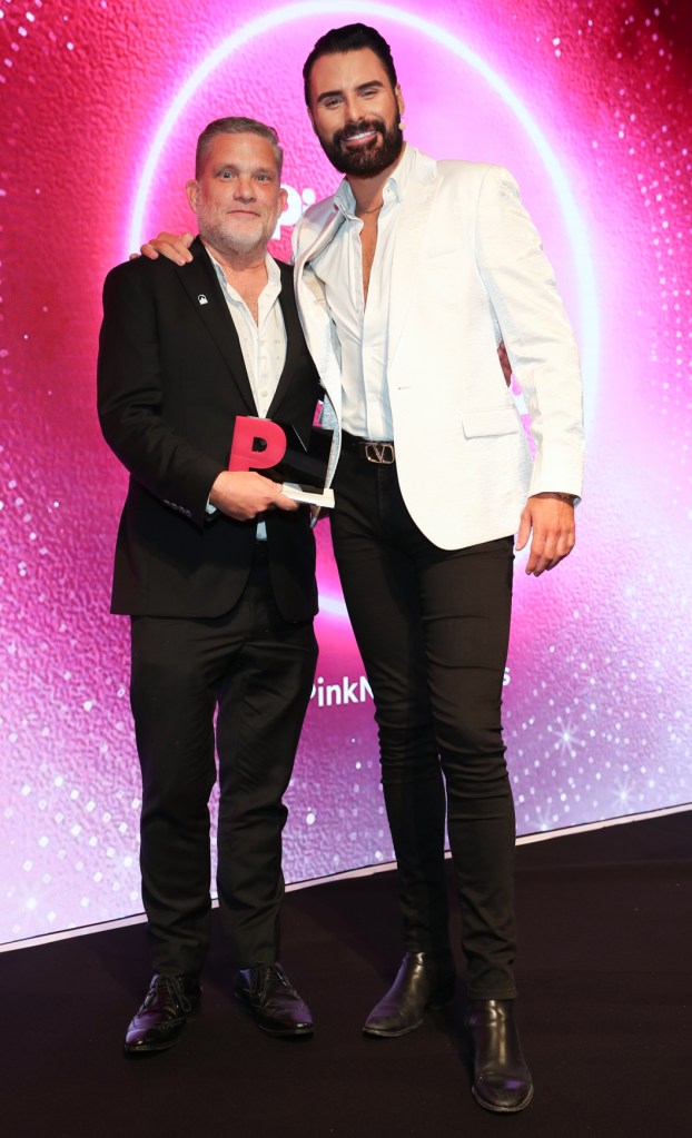 this is an image posing next to broadcast Rylan at an awards show