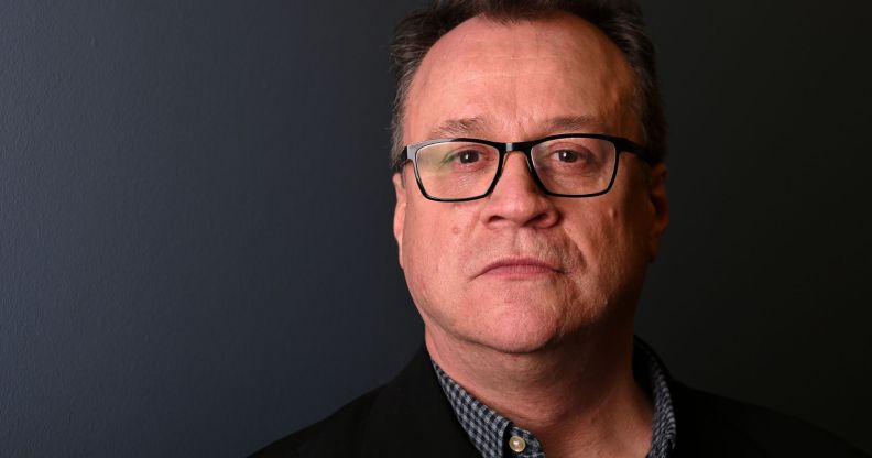 A headshot of Russell T Davies infront of a grey background.