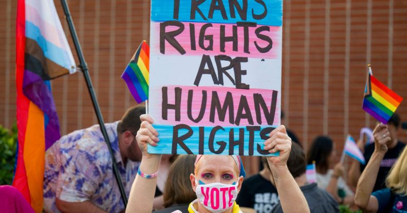 Protester holds up sign reading "trans rights are human rights"
