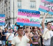 Protesters carry placards reading "trans rights are human rights"