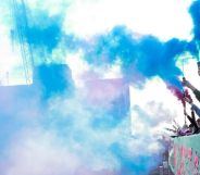 Activists let off smoke bombs in the trans flag colours in protest of the government's treatment of trans people.
