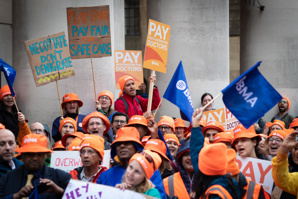 Consultants and junior doctors hold placards expressing their opinions during the Conservative Party Conference. 