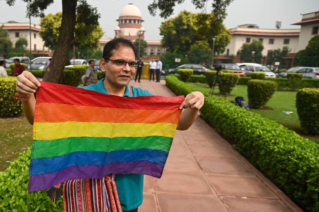 A member of the LGBTQ community holds a rainbow flag at the courtyard of the Supreme Court of India, during the judgement on same-sex marriage by Supreme Court in New Delhi, India on October 17, 2023. 