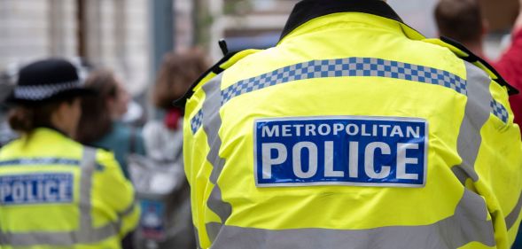 A picture of the back of the yellow and blue high vis jacket of a Metropolitan Police officer in London amid a rise in homophobic and transphobic hate crime in the UK