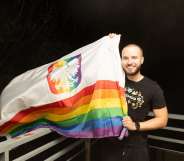 Bart Staszewski pictured holding a Pride flag outside after the election in Poland.