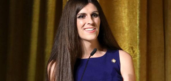 Danica Roem smiling on the stage of an event.