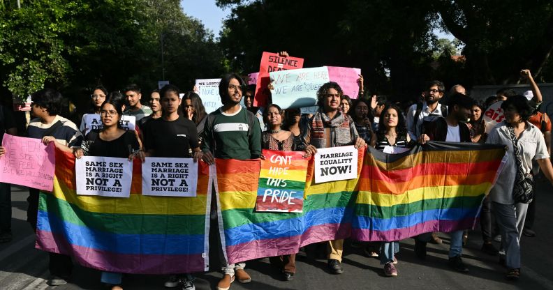 Members of the Student Federation of India (SFI) along with LGBTQ+ activists hold placards and shout slogans during a protest march against India's Supreme Court verdict on same-sex marriage, in New Delhi on October 18, 2023.