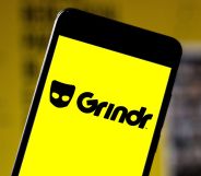 A phone with the logo of Grindr on it.