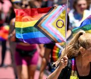 Woman carries an inclusive Pride flag during San Francisco Pride march in June 2022