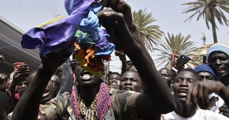 Protestors in Senegal ripping up an LGBTQ+ Pride flag.
