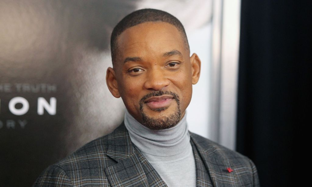 Will Smith in a grey roll neck and grey blazer.