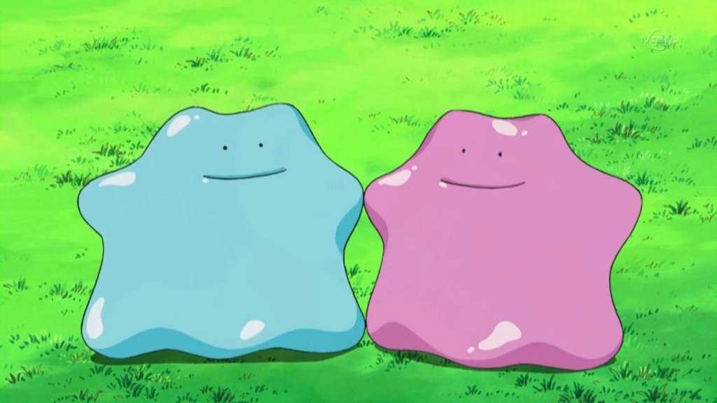 Image shows two blob-shaped Pokemon, one blue, one purple, standing on grass