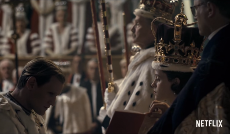 Prince Philip kneeling to Queen Elizabeth II at her coronation in the Netflix Series The Crown