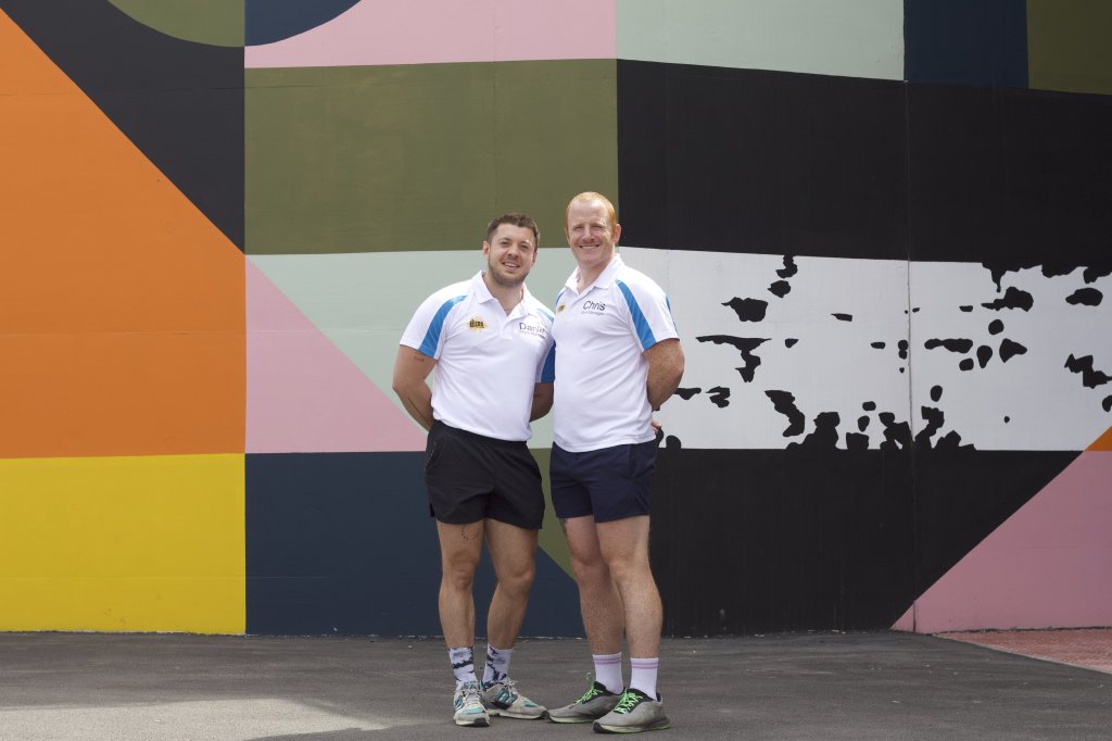 Daniel and Chris pictured outdoors posing for a photograph