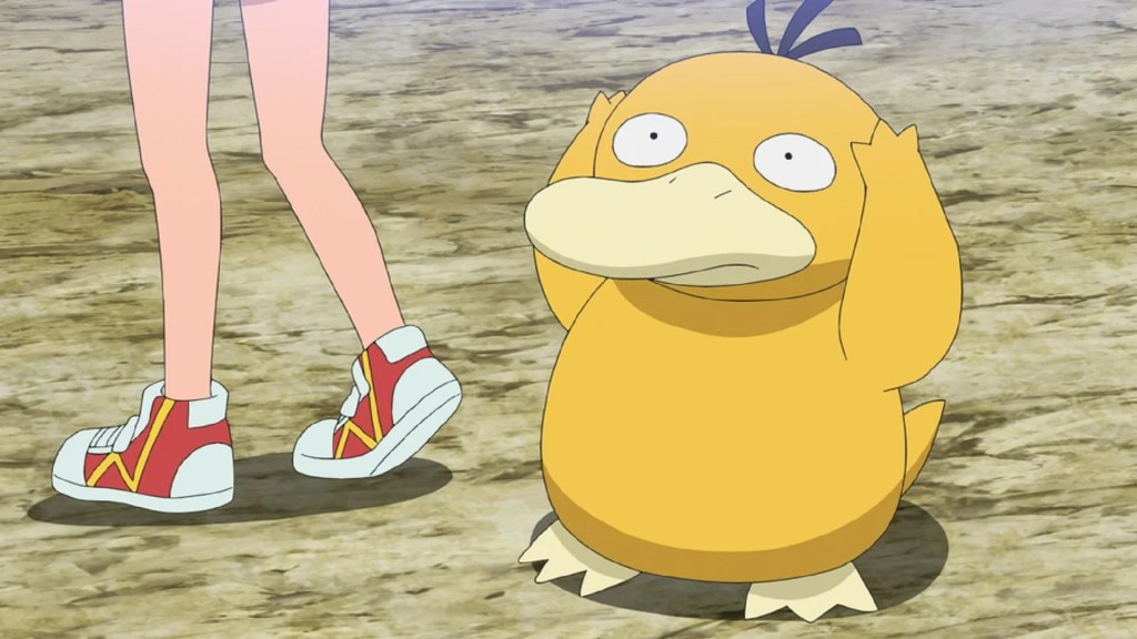 Image shows the Pokemon psyduck, a round, orange coloured duck with an anxious expression clutching its head