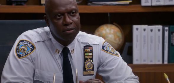 A still screenshot of Andrew Braugher wearing a police uniform while playing the Brooklyn Nine-Nine (also stylised Brooklyn 99) character Captain Raymond Holt