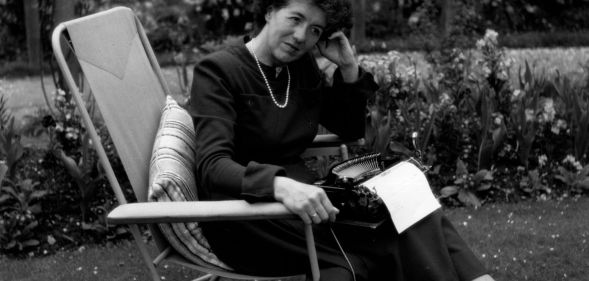 Children's writer Enid Blyton (1897 - 1968) sitting in her garden in Beaconsfield, Buckinghamshire