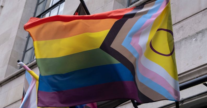 A Pride flag attached to a building.