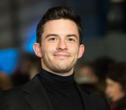 Jonathan Bailey in a black blazer and roll neck.