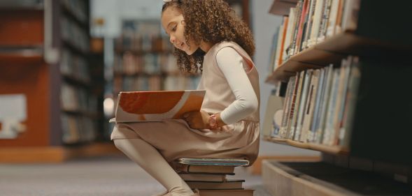 Girl reading a book in a library