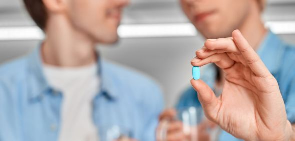 Generic image of a man holding a pill to illustrate a story about PrEP