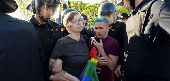 Russian riot police detain LGBTQ+ rights activists during a St Petersburg march in May 2019.