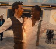 A screenshot of David Tennant and Ncuti Gatwa from the BBC series Doctor Who where Tennant and Gatwa are connected and being pulled apart
