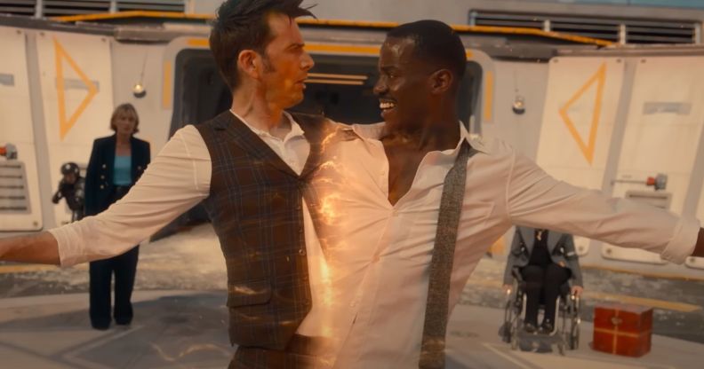 A screenshot of David Tennant and Ncuti Gatwa from the BBC series Doctor Who where Tennant and Gatwa are connected and being pulled apart